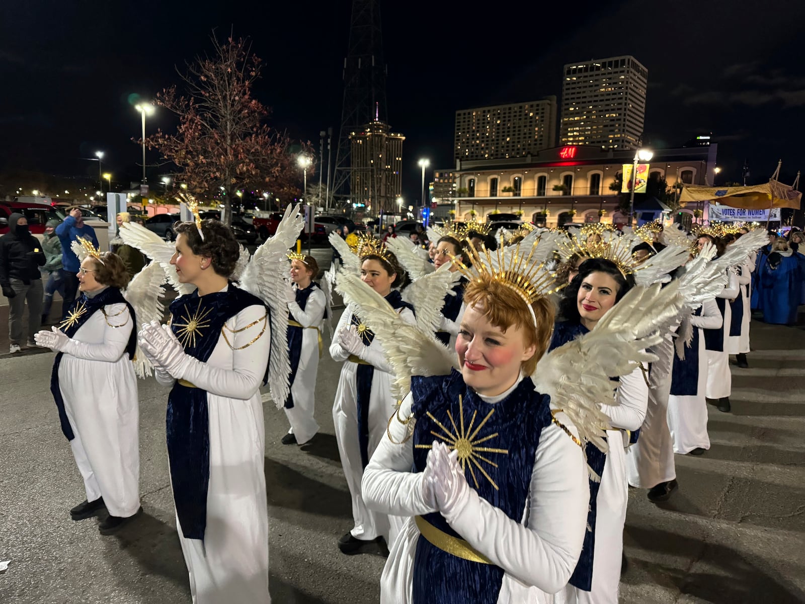 A procession of angels walks through New Orleans French Quarter as part of the Joan of Arc parade marking the start of Mardi Gras season earlyTuesday, Jan. 7, 2025, near where a rampaging truck driver killed 14 people on New Year's day. (AP Photo/Jack Brook)