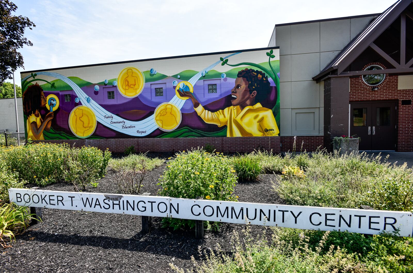 The 2019 StreetSpark mural titled " Inspiring the Future" is completed on the front of the Booker T. Washington Community Center on S. Front Street in Hamilton. The mural was designed by Jamie Schorsch. NICK GRAHAM/STAFF