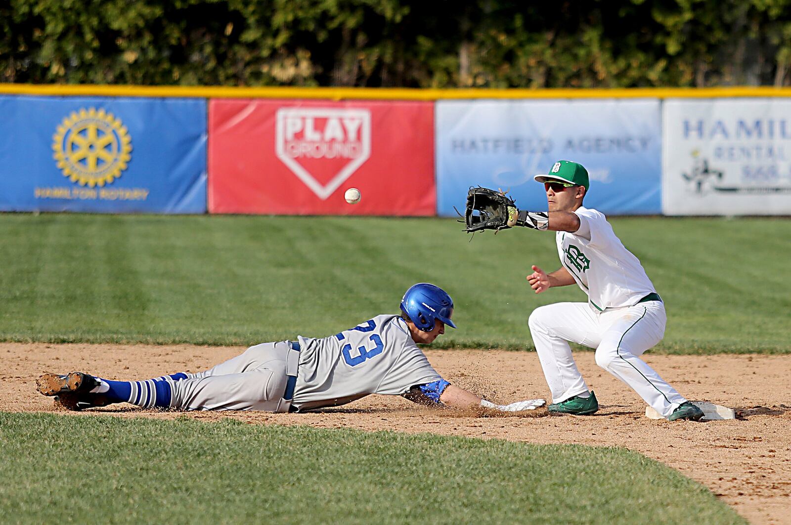 Badin shortstop Daunte DeCello tries to catch Defiance’s Blayne Robinson off second base Wednesday at Alumni Field in Hamilton. CONTRIBUTED PHOTO BY E.L. HUBBARD