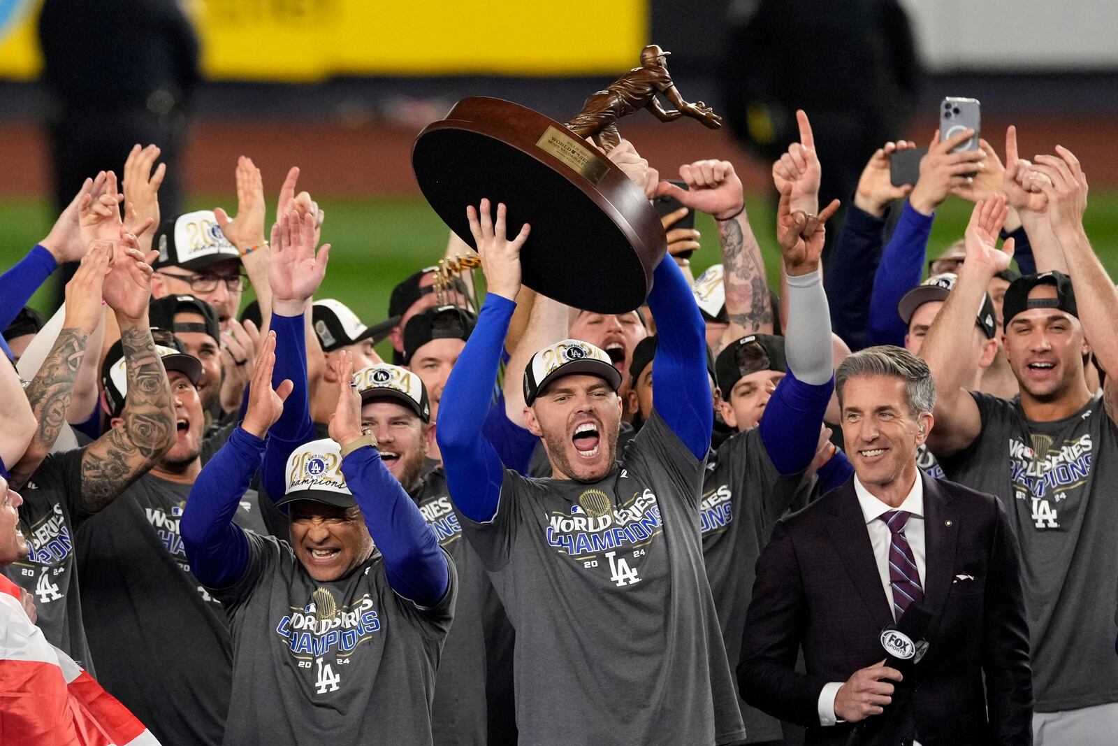 Los Angeles Dodgers' Freddie Freeman holds up the MVP trophy after the Dodgers beat the New York Yankees in Game 5 to win the baseball World Series, Thursday, Oct. 31, 2024, in New York. (AP Photo/Seth Wenig)