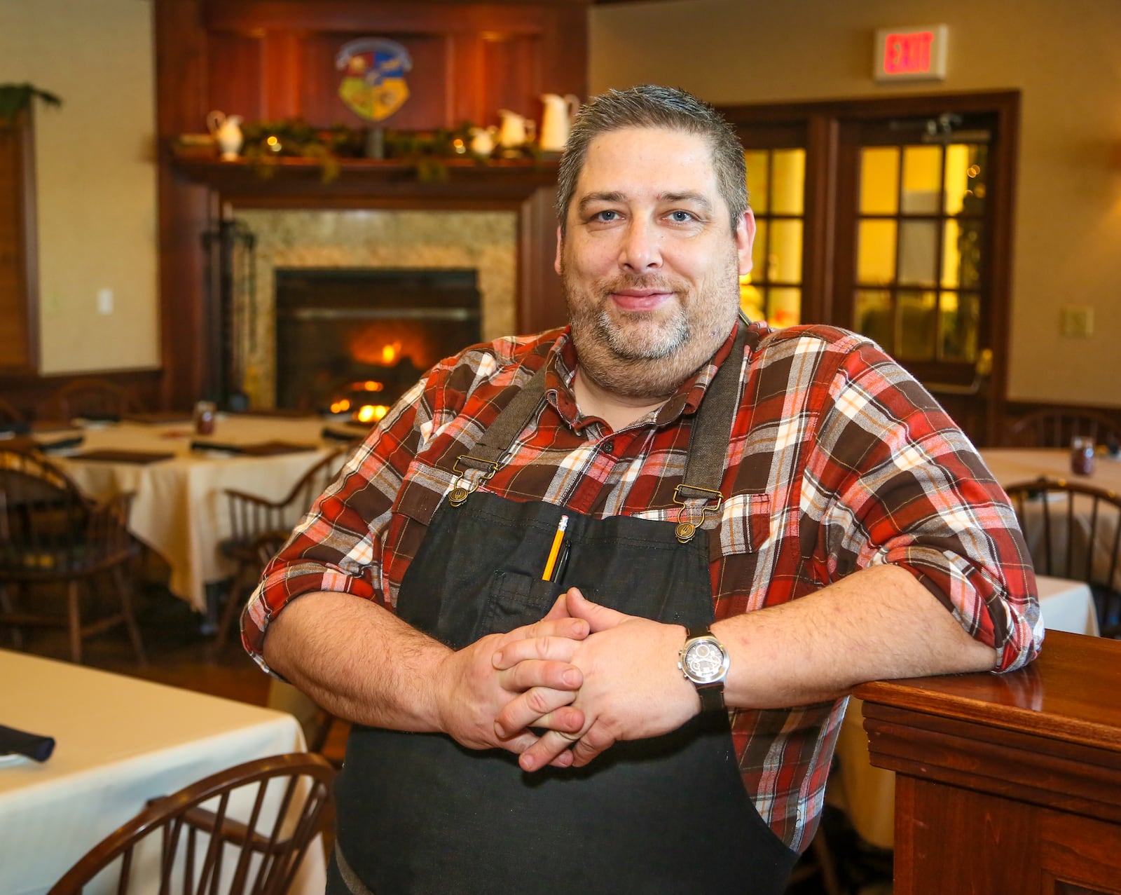 Jared Whalen, executive chef of the Coach House, stands in the dining room of the tavern and grill,  Thursday, Dec. 15. The Coach House became a public restaurant this year after previously being a  members-only establishment. GREG LYNCH / STAFF