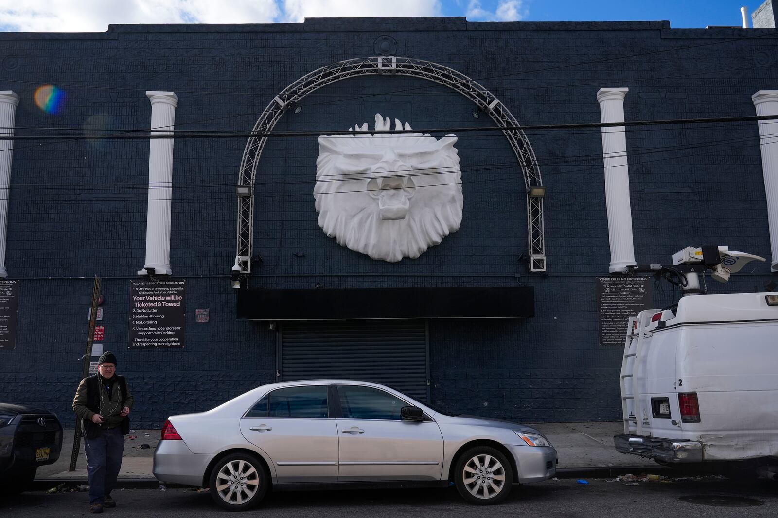 Members of the media work in front of the nightclub Amazura in the Queens borough of New York, Thursday, Jan. 2, 2025. (AP Photo/Seth Wenig)