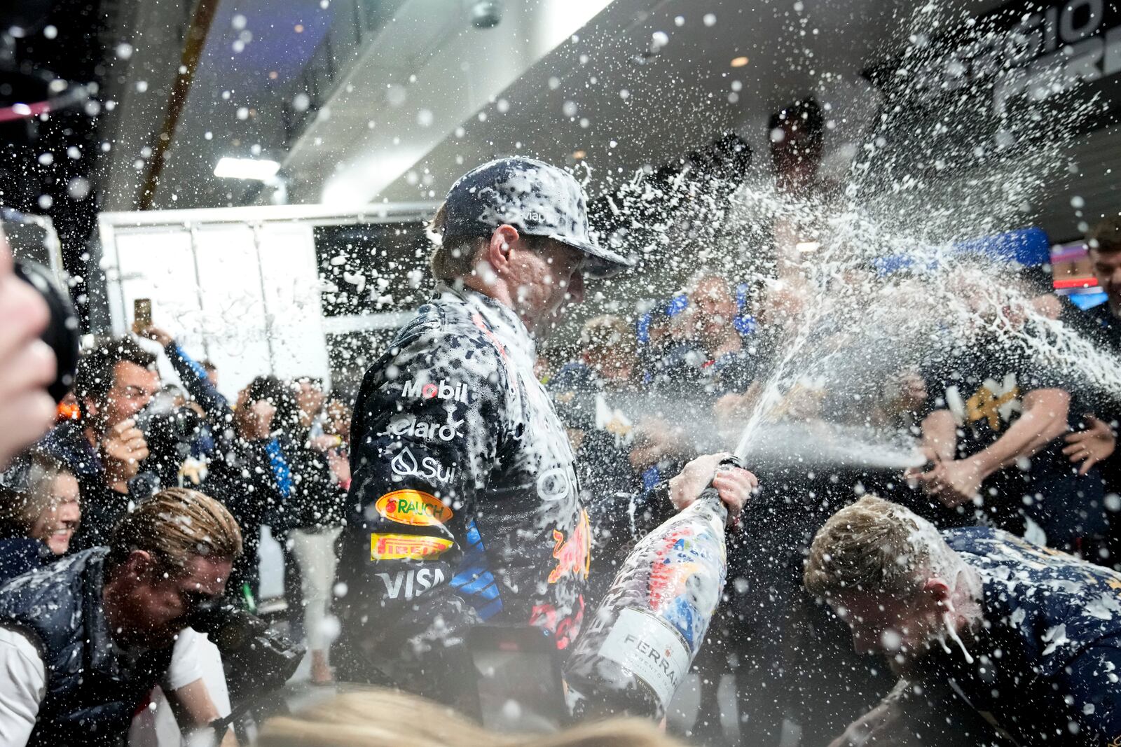 Red Bull driver Max Verstappen, of the Netherlands, celebrates winning the Formula 1 championship with his team after the F1 Las Vegas Grand Prix auto race, Sunday, Nov. 24, 2024, in Las Vegas. (AP Photo/Matt York)