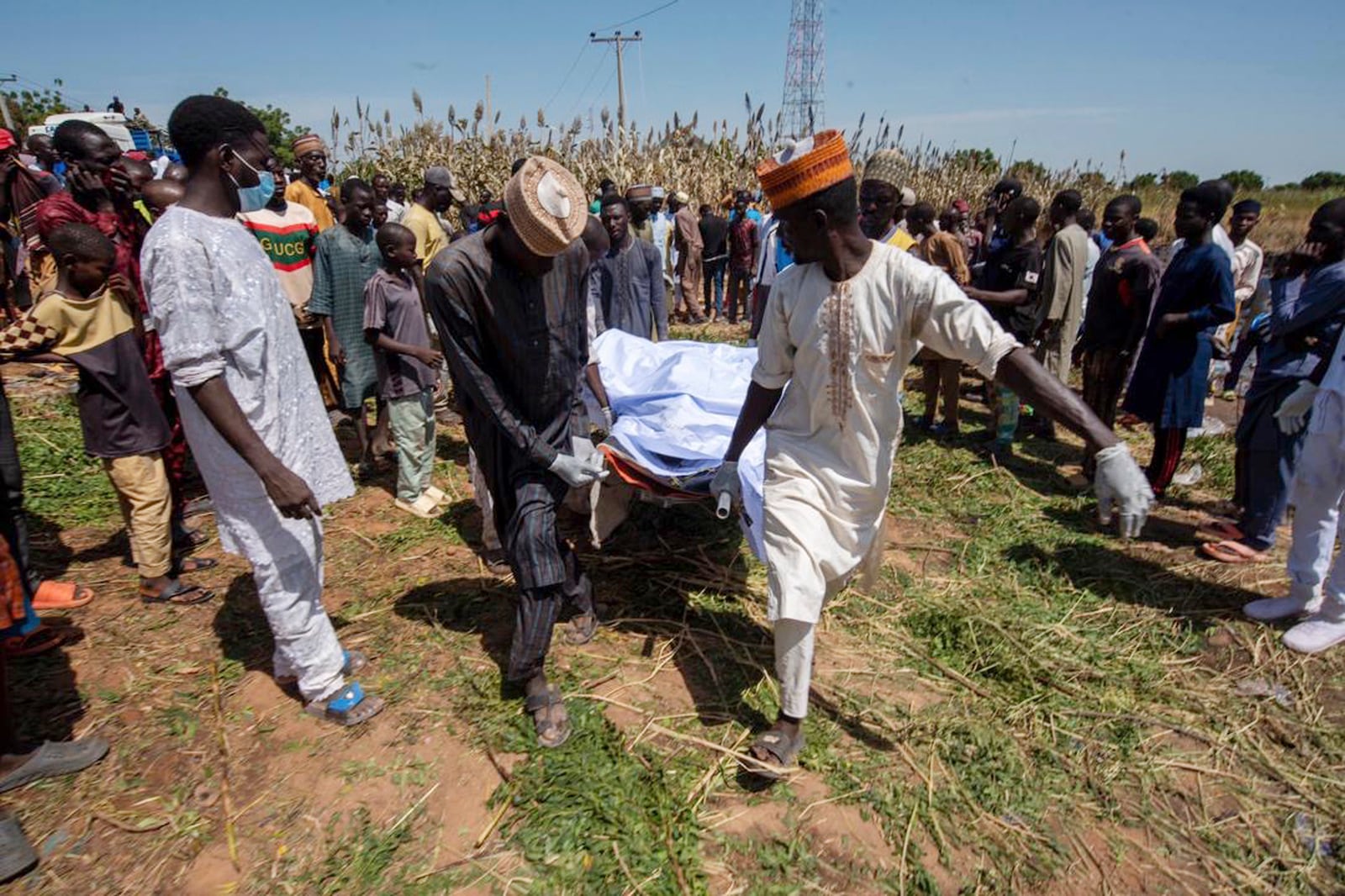 People carry the body of a victim of a tanker explosion ahead of a funeral in Majiya town, Nigeria, Wednesday, Oct. 16, 2024. (AP Photo/Sani Maikatanga)