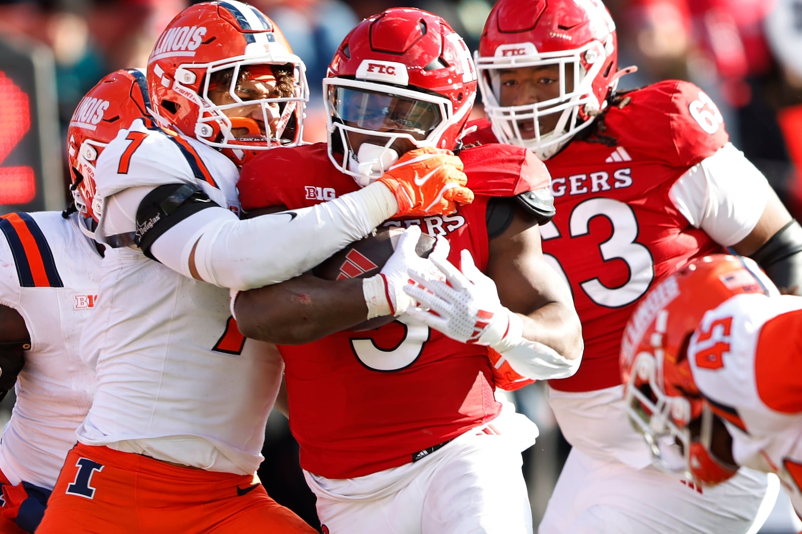 Rutgers running back Kyle Monangai (5) is tackled by Illinois defensive back Matthew Bailey (7) during the first half of an NCAA college football game, Saturday, Nov. 23, 2024, in Piscataway, N.J. (AP Photo/Rich Schultz)