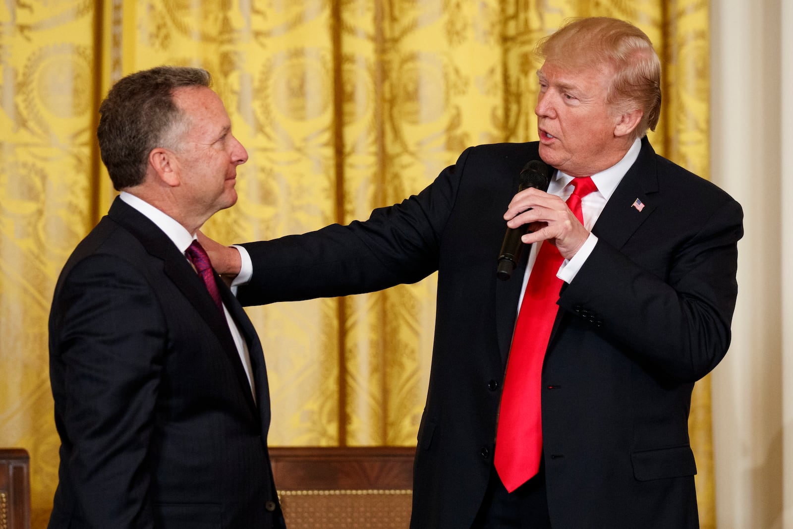 FILE - President Donald Trump speaks to businessman Steve Witkoff, who lost his son Andrew to a prescription drug overdose, during the White House Opioid Summit in the East Room of the White House, March 1, 2018, in Washington. (AP Photo/Evan Vucci, File)