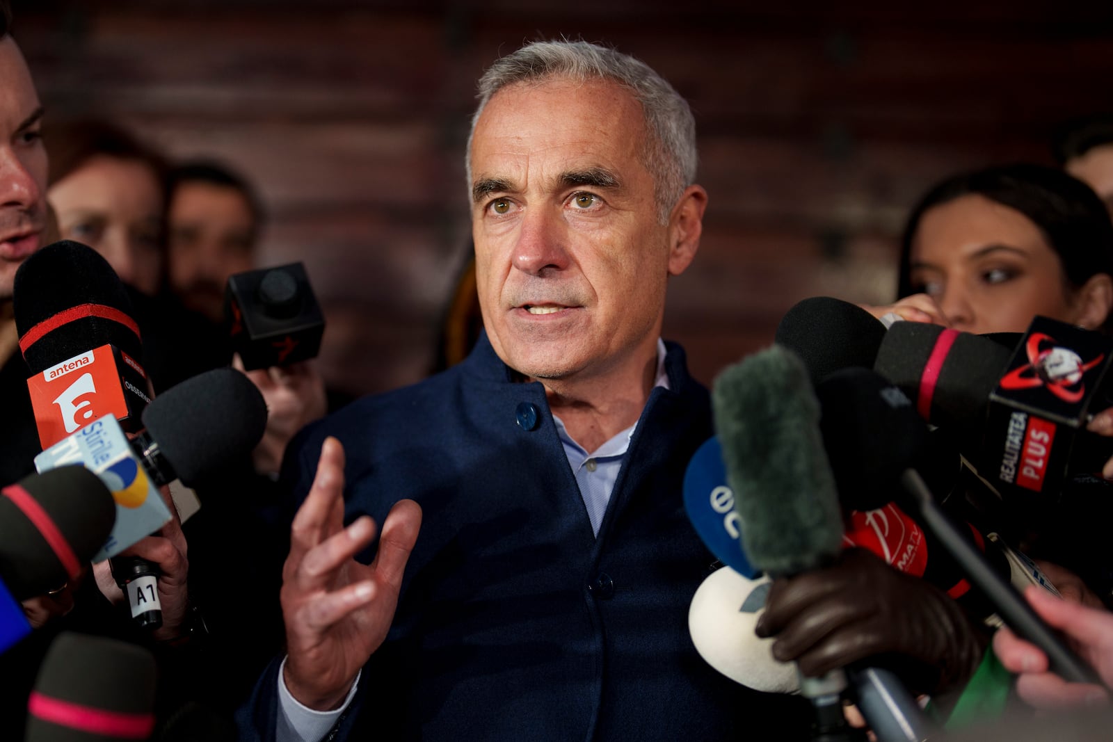 Calin Georgescu, running as an independent candidate for president gestures while delivering a speech to media, in Izvorani, Romania, Tuesday, Nov. 26, 2024, after making it to the Dec. 8 election runoff. (AP Photo/Vadim Ghirda)