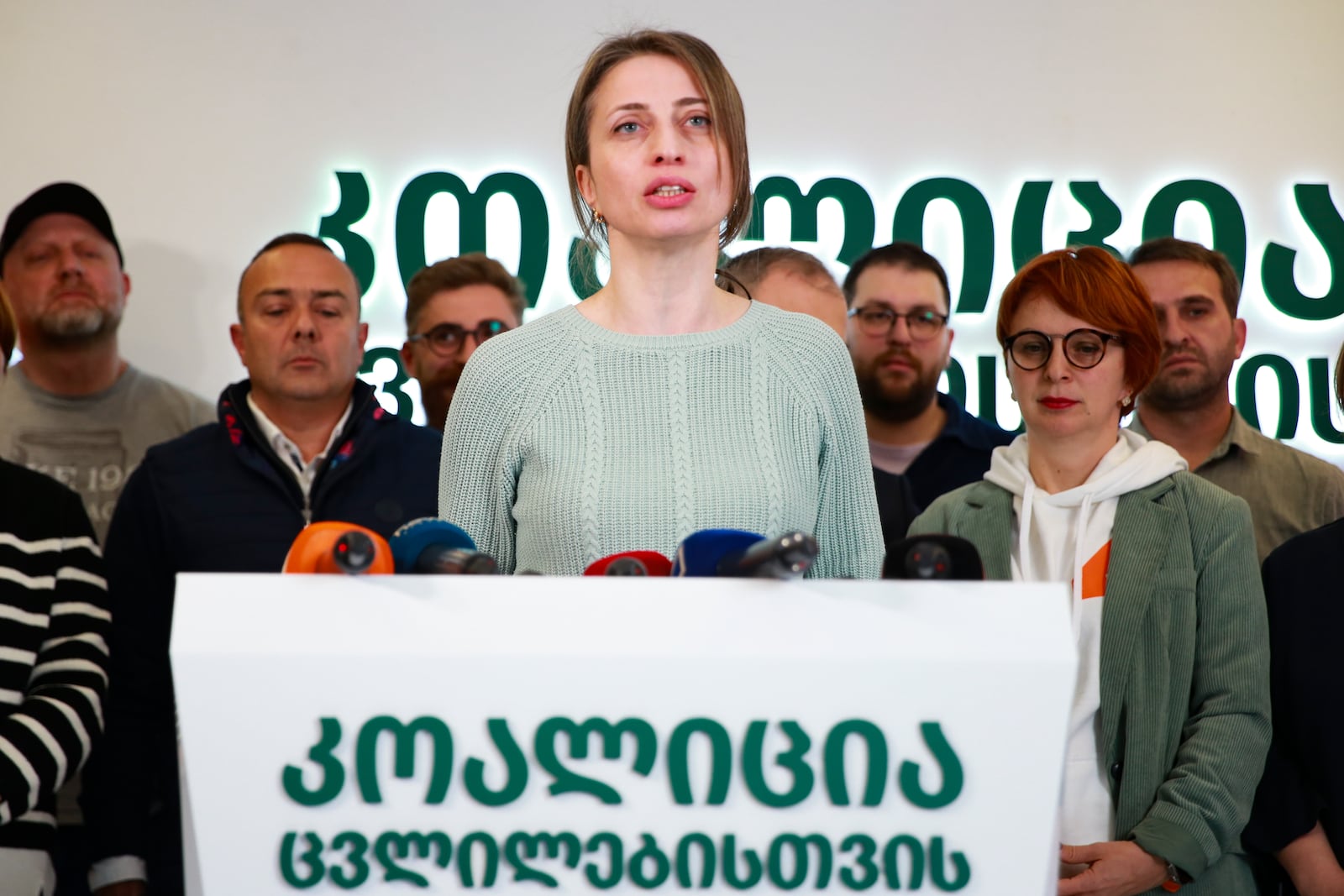 Nana Malashkhia, who leads the Coalition for Change parliament list, center, speaks to the media at coalition's headquarters after the parliamentary election in Tbilisi, Georgia, Sunday, Oct. 27, 2024. (AP Photo/Zurab Tsertsvadze)