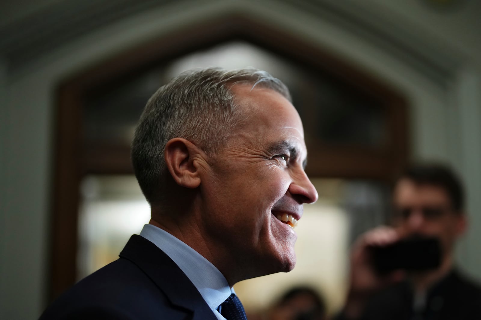 Liberal Leader Mark Carney talks to media as he leaves a caucus meeting in Ottawa, Monday, March 10, 2025. (Sean Kilpatrick/The Canadian Press via AP)