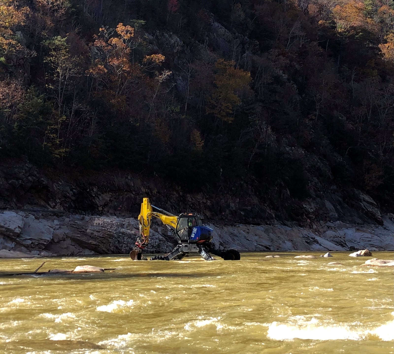 This photo provided by Patrick Mannion shows heavy equipment in the Nolichucky River gorge, between Poplar, N.C., and Erwin, Tenn., on Oct. 30, 2024, where flooding from September’s Hurricane Helene devastated this mountainous region on the Tennessee-North Carolina border. (Patrick Mannion via AP)