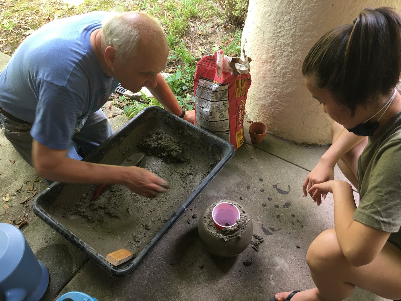 Dan Sauer and his granddaughter Lila mix concrete. CONTRIBUTED