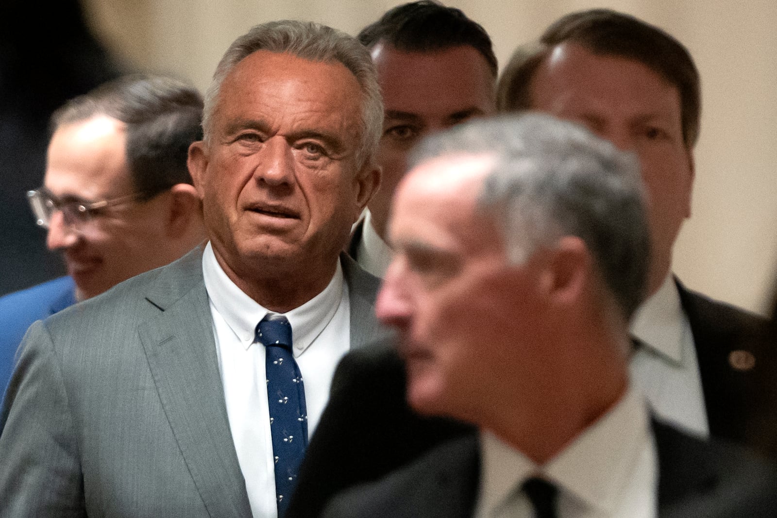 Robert Kennedy Jr., President-elect Donald Trump's pick to lead the Health and Human Services Department, walks between meetings with senators on Capitol Hill, Tuesday, Dec. 17, 2024, in Washington. (AP Photo/Mark Schiefelbein)