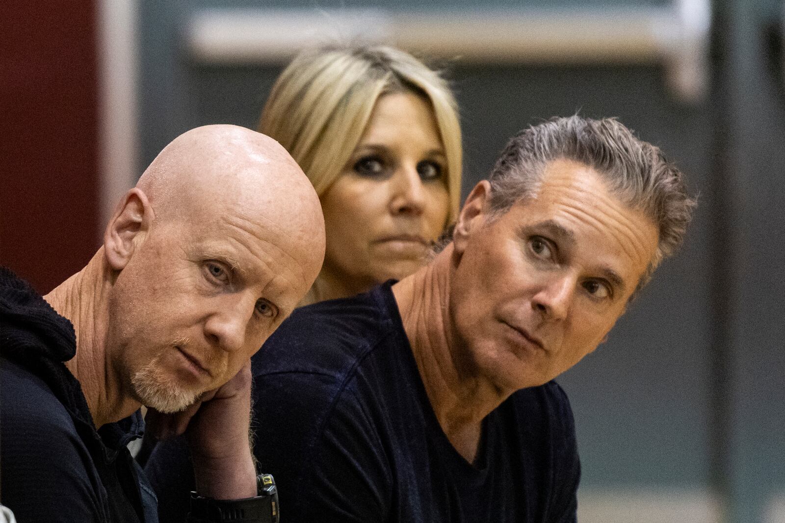 GoFundMe CEO Tim Cadogan, left, The Change Reaction founders Greg Perlman, left, and his wife Jodi attend an event at the gymnasium of Pasadena City College during which The Change Reaction foundation will be handing out about 1,000 checks of between $2,500-$5,000 to people impacted by the Eaton Fire, Tuesday, Jan. 28, 2025 in Pasadena, Calif. (AP Photo/Etienne Laurent)