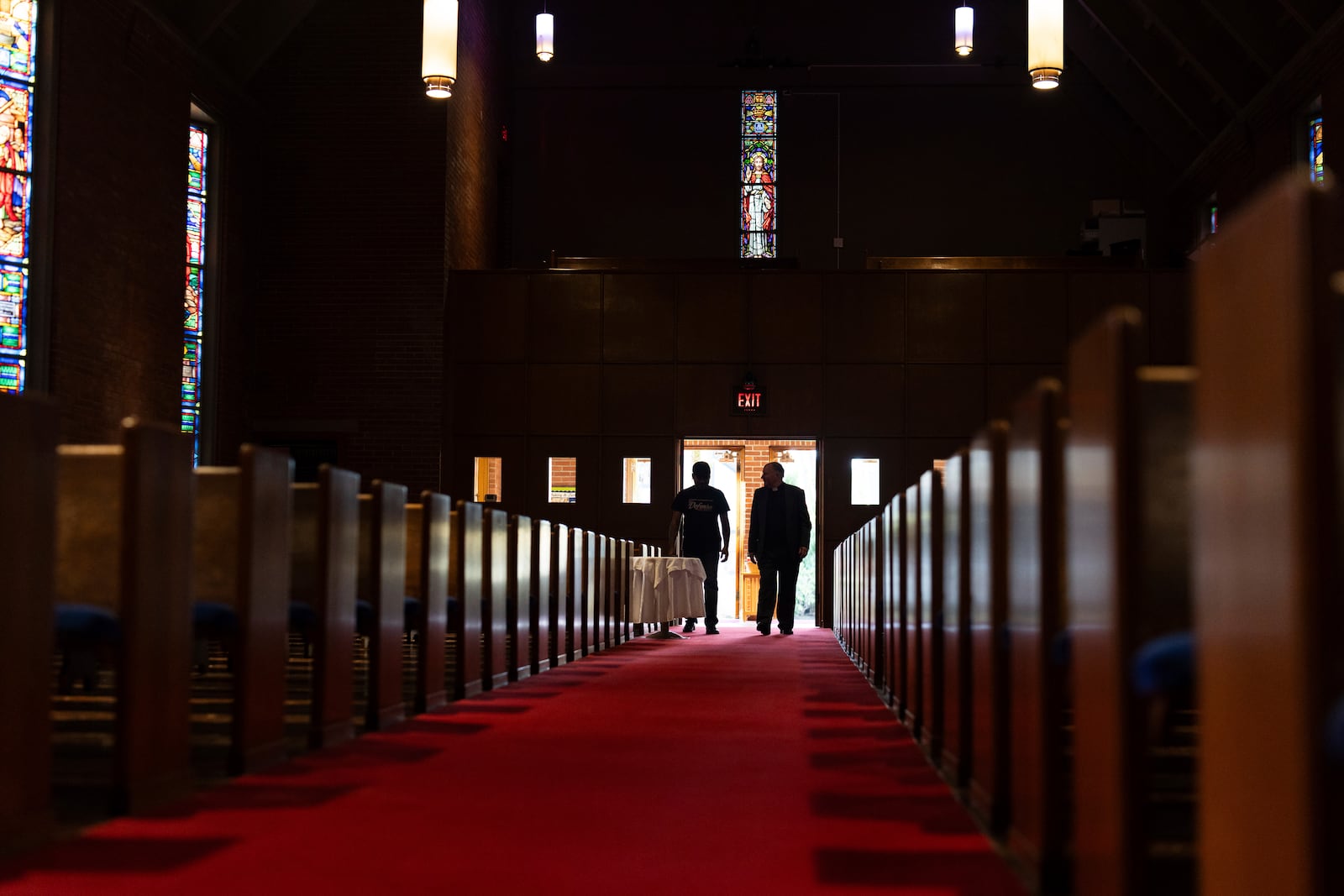 The Rev. W. J. Mark Knutson, right, walks with Juan Francisco Aguirre-Velasquez at the Augustana Lutheran Church on Thursday, Jan. 9, 2025, in Portland, Oregon. Aguirre-Velasquez, originally from El Salvador, sought sanctuary at the church to avoid deportation in 2014. (AP Photo/Jenny Kane)