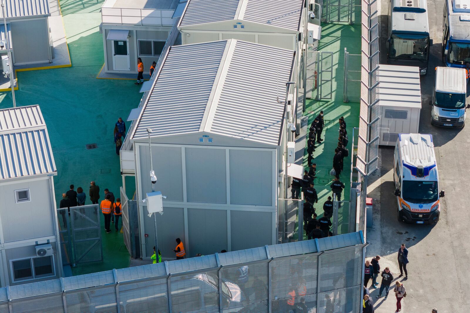 An aerial view of a migrant reception facility at the port of Shengjin, northwestern Albania, Friday, Nov. 8, 2024, as a second group of eight migrants were intercepted in international waters. (AP Photo/Vlasov Sulaj)