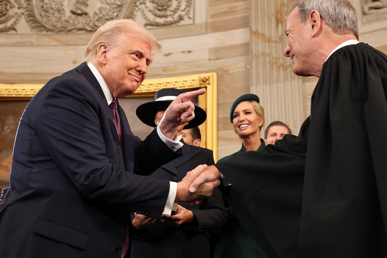 President Donald Trump gestures to Supreme Court Chief Justice John Roberts after being sworn in as president during the 60th Presidential Inauguration in the Rotunda of the U.S. Capitol in Washington, Monday, Jan. 20, 2025. (Chip Somodevilla/Pool Photo via AP)