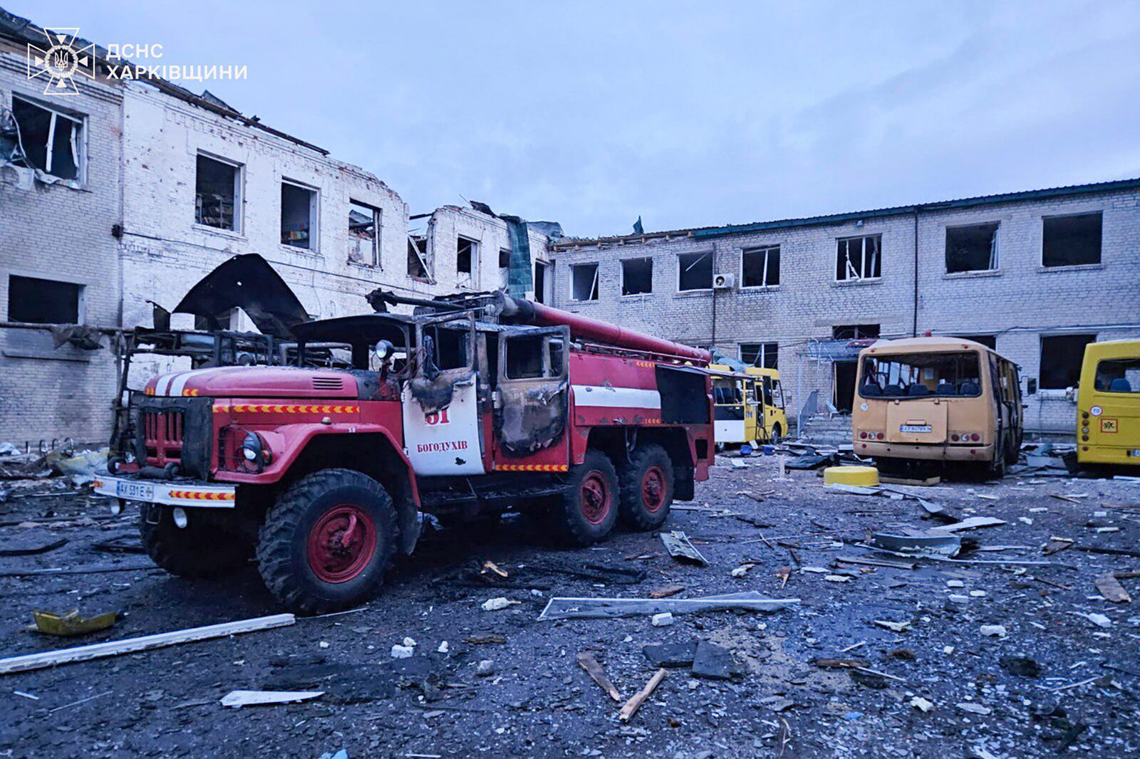 In this photo provided by the Ukrainian Emergency Service, a fire engine and school buses burn after a Russian drone hit them when firefighters were putting out the fire at a lyceum following Russian drone attack in Bohodukhiv, Kharkiv region, Ukraine, Saturday, March 15, 2025. (Ukrainian Emergency Service via AP)