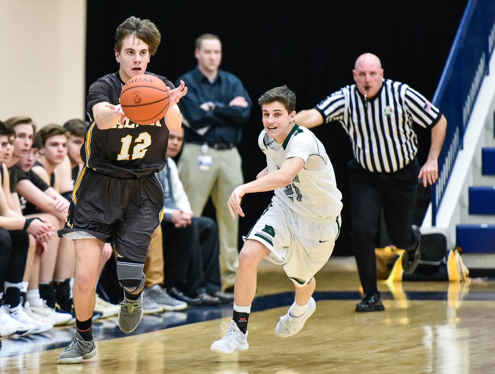 Alter’s Jack Smith makes a pass while being defended by Badin’s Sam Mathews on Tuesday night during a Division II sectional semifinal at Fairmont’s Trent Arena. NICK GRAHAM/STAFF