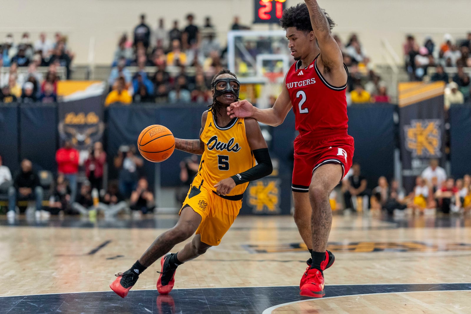 Kennesaw State guard Simeon Cottle (5) dribbles against defender Rutgers guard Dylan Harper (2) during the first half of an NCAA college basketball game, Sunday, Nov. 24, 2024, in Kennesaw, Ga. (AP Photo/Erik Rank)