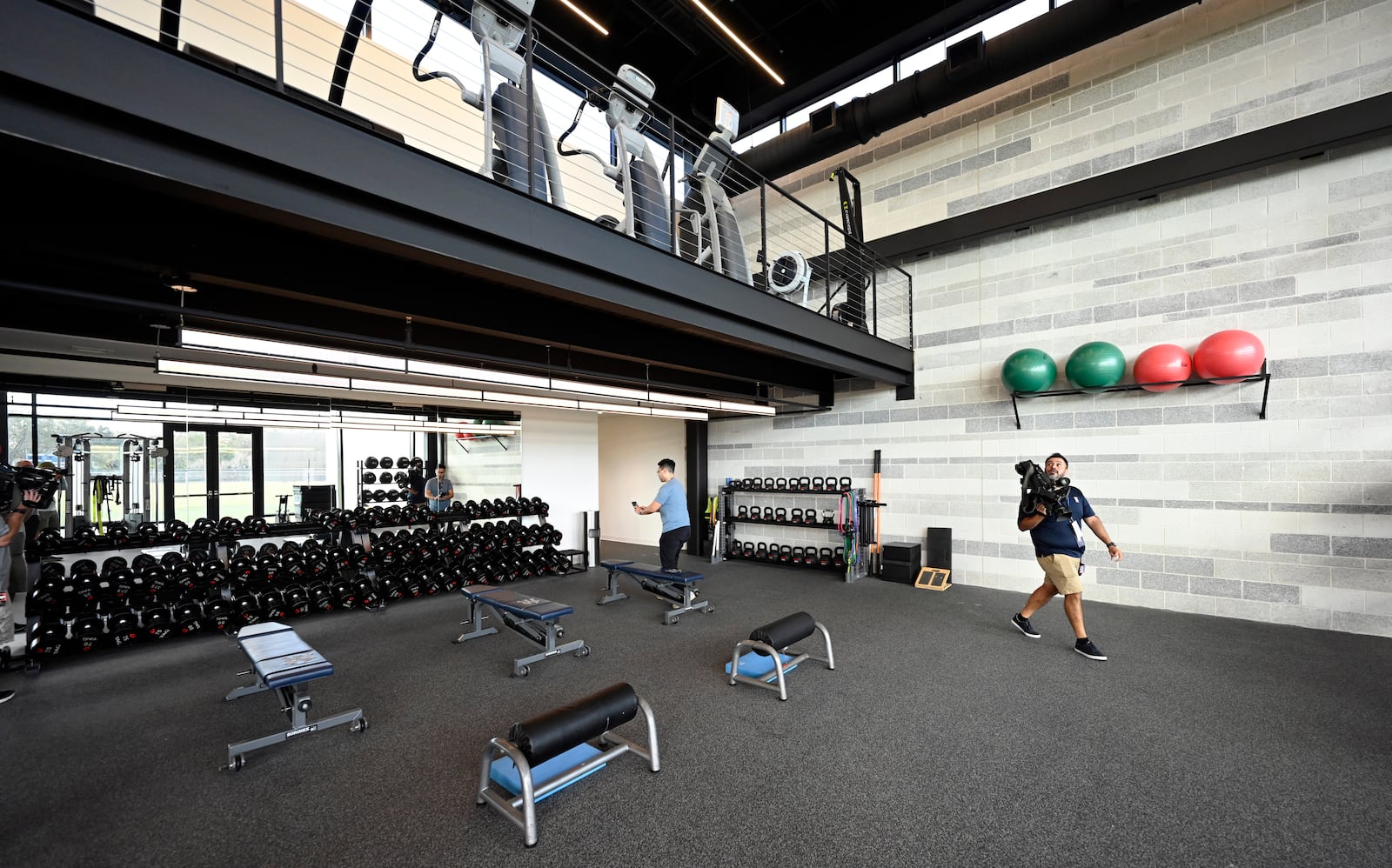 Members of the media look over the New York Yankees weight room during a tour of the upgraded team spring training facilities Thursday, Feb 13, 2025 at George M. Steinbrenner Field, in Tampa, Fla. (AP Photo/Steve Nesius)