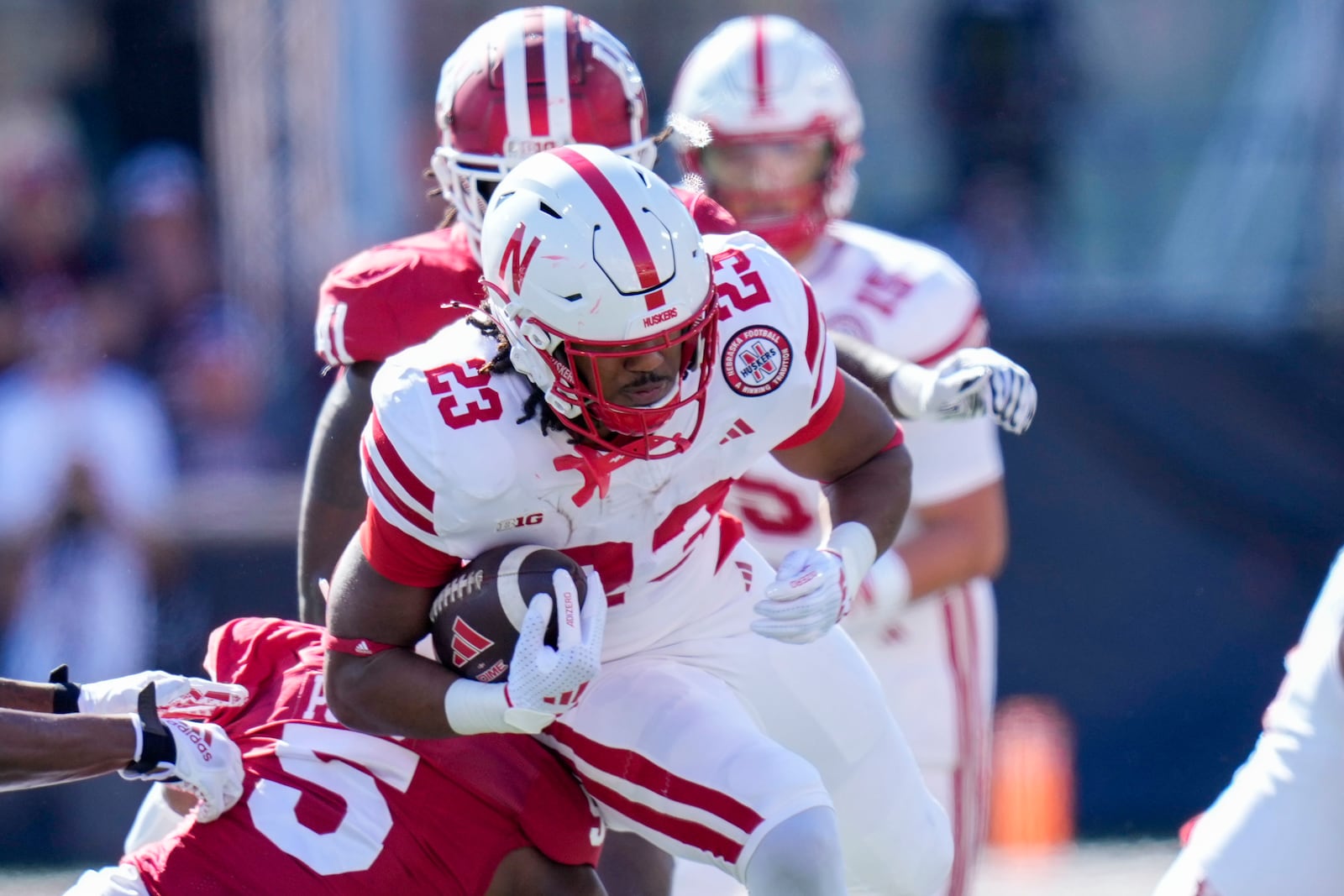 Nebraska running back Dante Dowdell (23) gets tackled by Indiana defensive back D'Angelo Ponds (5) during the first half of an NCAA college football game in Bloomington, Ind., Saturday, Oct. 19, 2024. (AP Photo/AJ Mast)