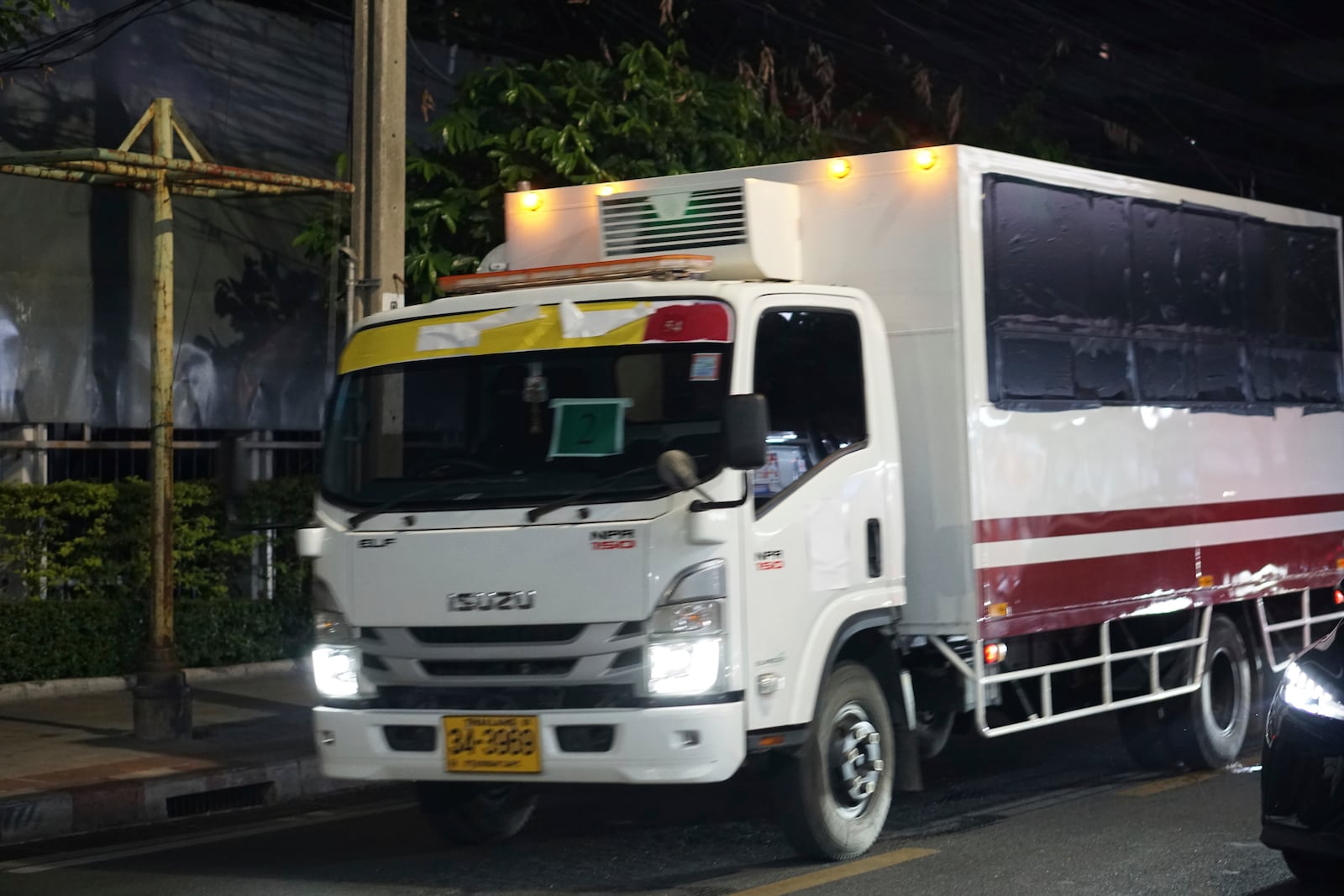 This photo provided by Thailand's daily web newspaper Prachatai shows a truck with black tape covering the windows leave a detention center in Bangkok, Thailand Thursday, Feb. 27, 2025.(Nuttaphol Meksobhon/Prachatai via AP)