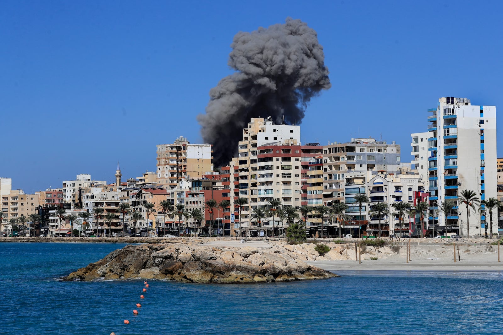 Smoke rises from buildings hit in an Israeli airstrike in Tyre, Lebanon, Wednesday, Oct. 23, 2024. (AP Photo/Mohammad Zaatari)