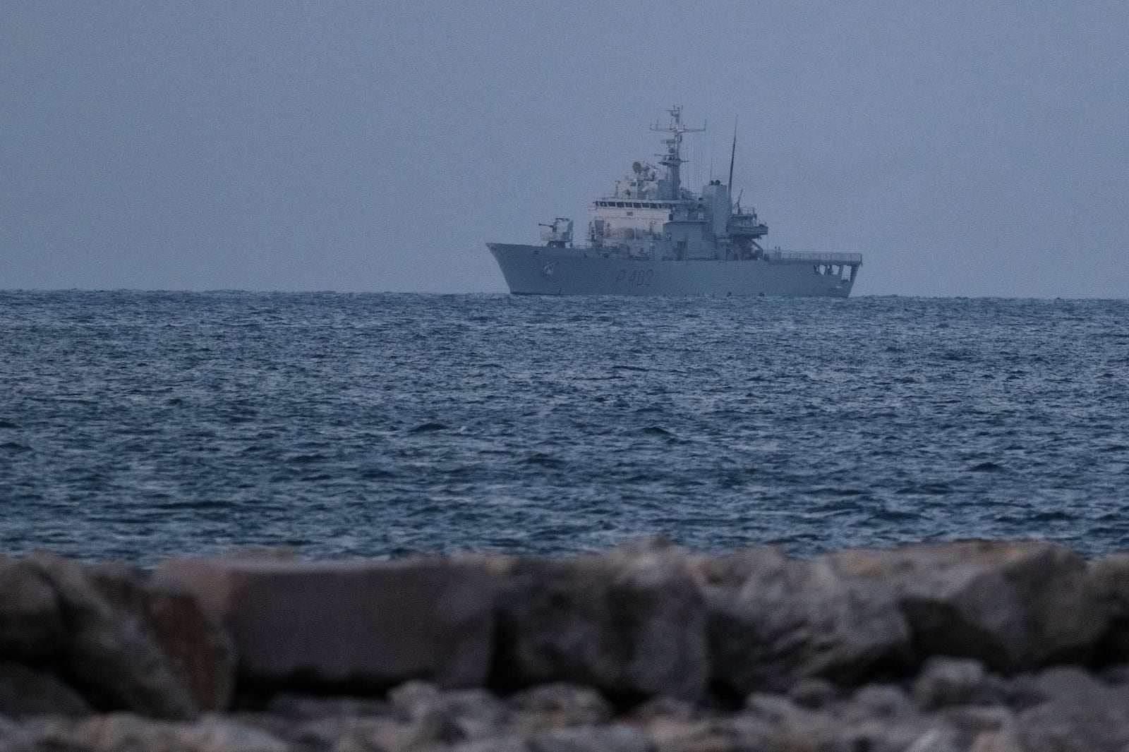 An Italian navy ship approaches the port of Shengjin northwestern Albania Wednesday, Oct. 16, 2024 carrying the first group of migrants who were intercepted in international waters and whose asylum applications will be processed in Albania instead of in Italy, under a five-year agreement between the two countries. (AP Photo/Vlasov Sulaj)