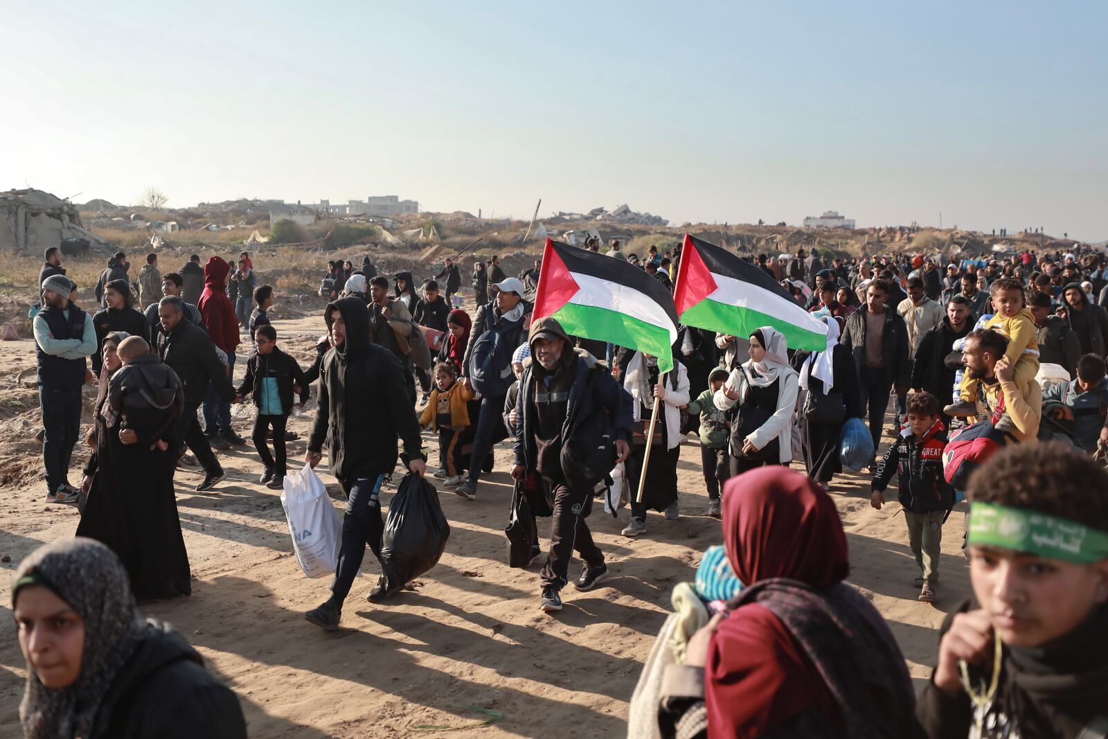 Displaced Palestinians arrive in the northern Gaza Strip, following Israel's decision to allow thousands of them to go back for the first time since the early weeks of the 15-month war with Hamas, Monday, Jan. 27, 2025. (AP Photo/Abed Hajjar)