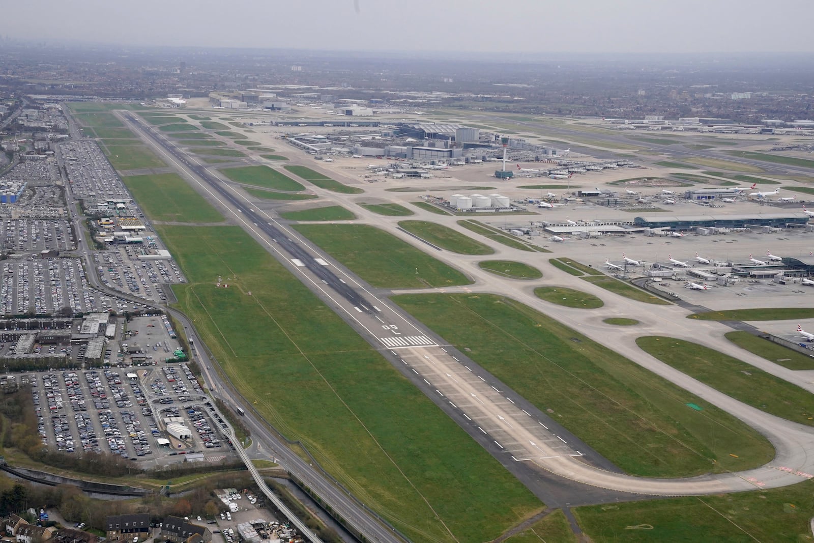 An empty runway at Heathrow Airport, which was closed following a fire in the nearby North Hyde electrical substation, in London, Friday March 21, 2025. (Jonathan Brady/PA via AP)