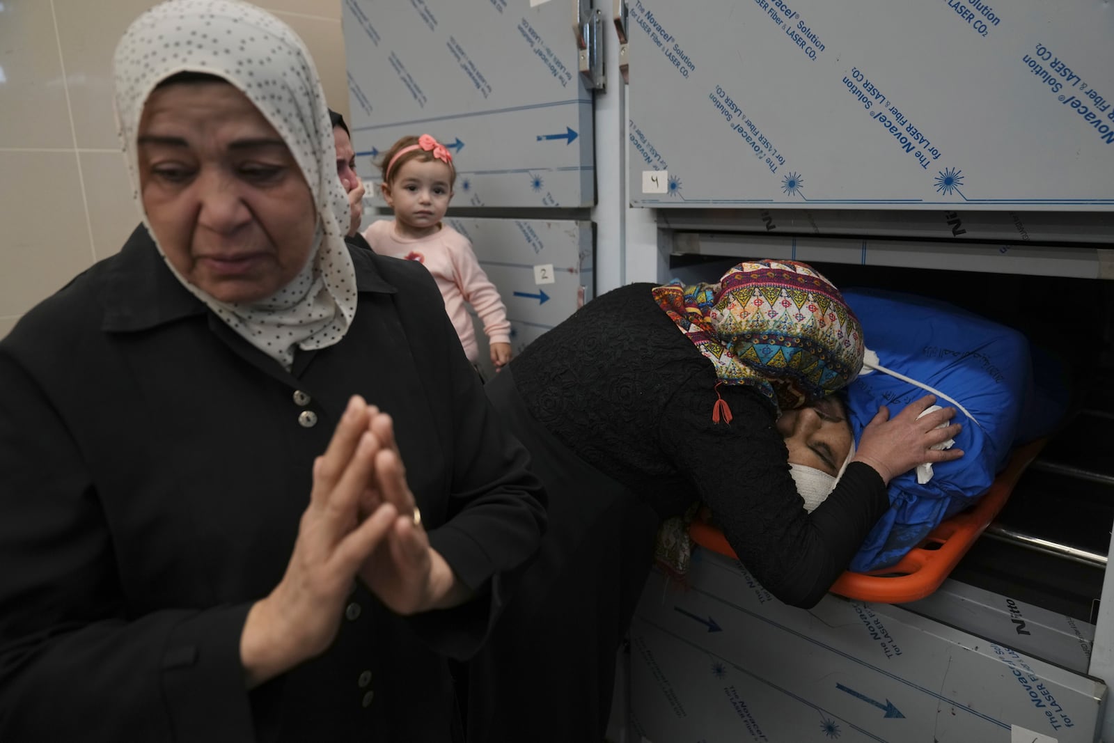 Relatives of Palestinian Husam Mallah, 28 take the last look at his body in the morgue of a local hospital, in the West Bank city of Tulkarem, Thursday, Oct. 31, 2024. (AP Photo/Nasser Nasser)