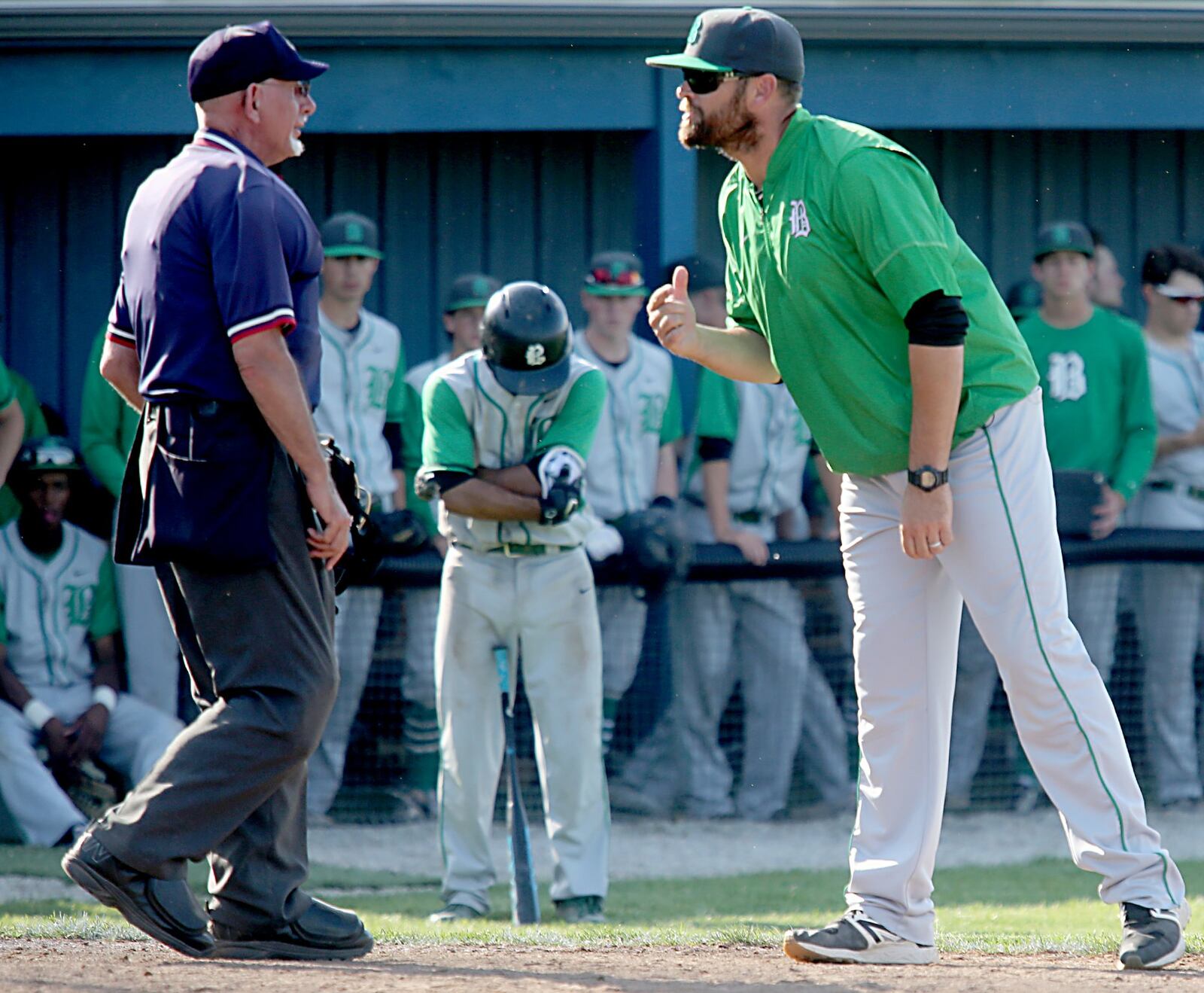 Badin coach Brion Treadway questions the call that sent Daunte DeCello (with head down) back to the plate after getting hit with a pitch in the seventh inning of Thursday’s Division II sectional final against Chaminade Julienne at Miamisburg. CONTRIBUTED PHOTO BY E.L. HUBBARD