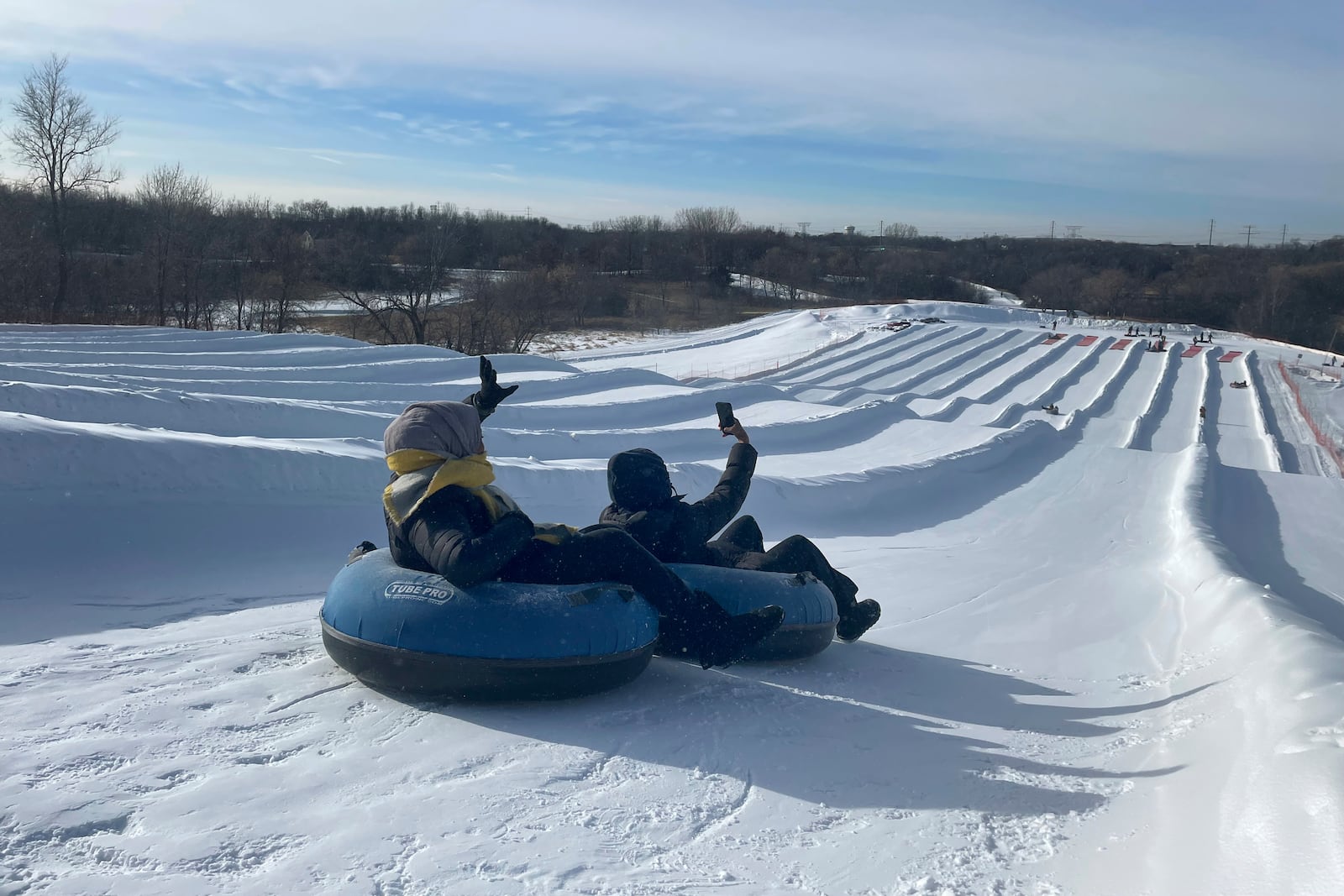 Sisters Ruun Mahamud, left, and Nawal Hirsi go snow tubing during an outing organized by the group Habib founded to promote outdoors activities among Muslim women, at Elm Creek Park Reserve in Maple Grove, Minn., on Jan. 4, 2025. (AP Photo/Giovanna Dell'Orto)