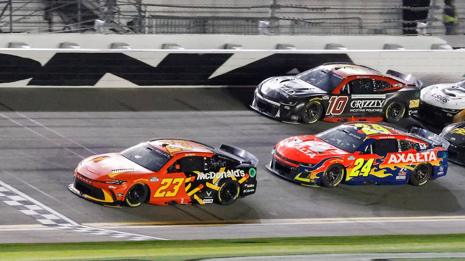 Bubba Wallace (23) wins the first of two NASCAR Daytona 500 qualifying auto races as he crosses the finish line ahead of William Byron (24) and Ty Dillon (10) at Daytona International Speedway, Thursday, Feb. 13, 2025, in Daytona Beach, Fla. (AP Photo/Terry Renna)