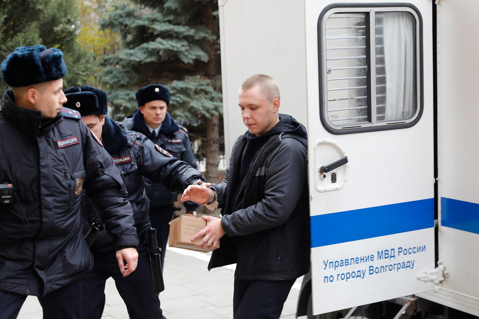 Nikita Zhuravel, right, is escorted by the police to a court prior to a hearing of a treason case in Volgograd, Russia, Thursday, Nov. 14, 2024. (AP Photo)