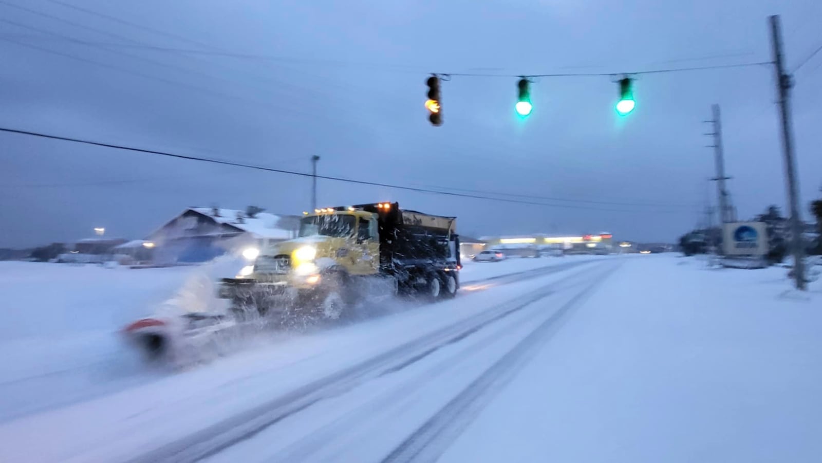 A snowplow clears the street of snow in Avon, N.C., on Wednesday, Jan. 22, 2025. (Joy Crist/Island Free Press via AP)