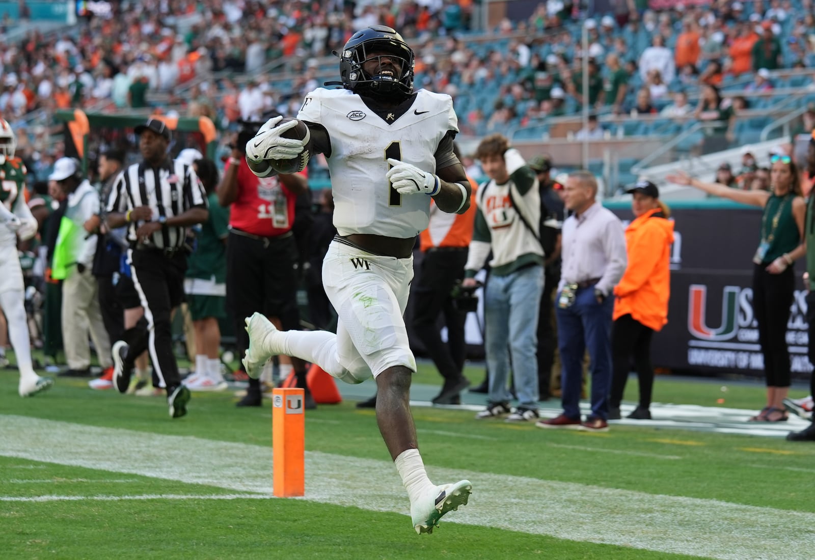 Wake Forest running back Demond Claiborne (1) runs back a kick return for a touchdown during the first half of an NCAA college football game against Miami, Saturday, Nov. 23, 2024, in Miami Gardens, Fla. (AP Photo/Lynne Sladky)