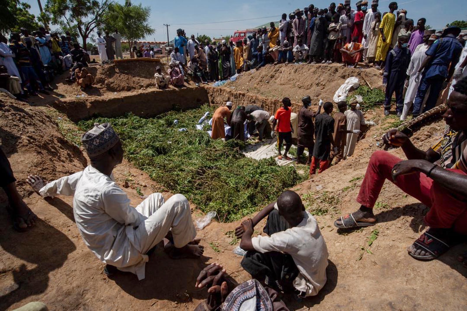 People prepare bodies for burial, following a tanker explosion in Majiya town, Nigeria, Wednesday, Oct. 16, 2024. (AP Photo/Sani Maikatanga)