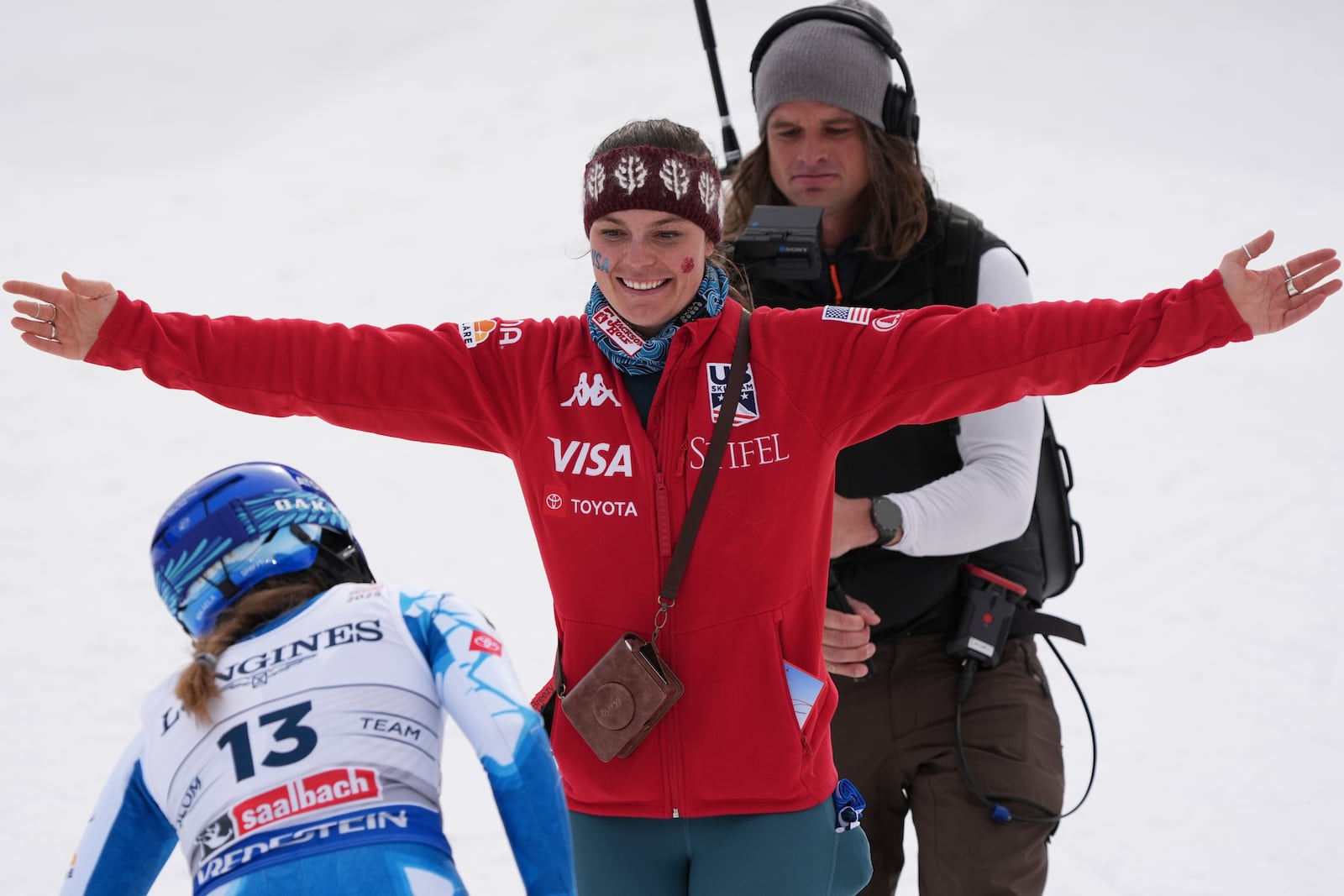 United States' Breezy Johnson, right, hugs teammate. United States' Mikaela Shiffrin at the finish area of a slalom run of a women's team combined event, at the Alpine Ski World Championships, in Saalbach-Hinterglemm, Austria, Tuesday, Feb. 11, 2025. (AP Photo/Giovanni Auletta)