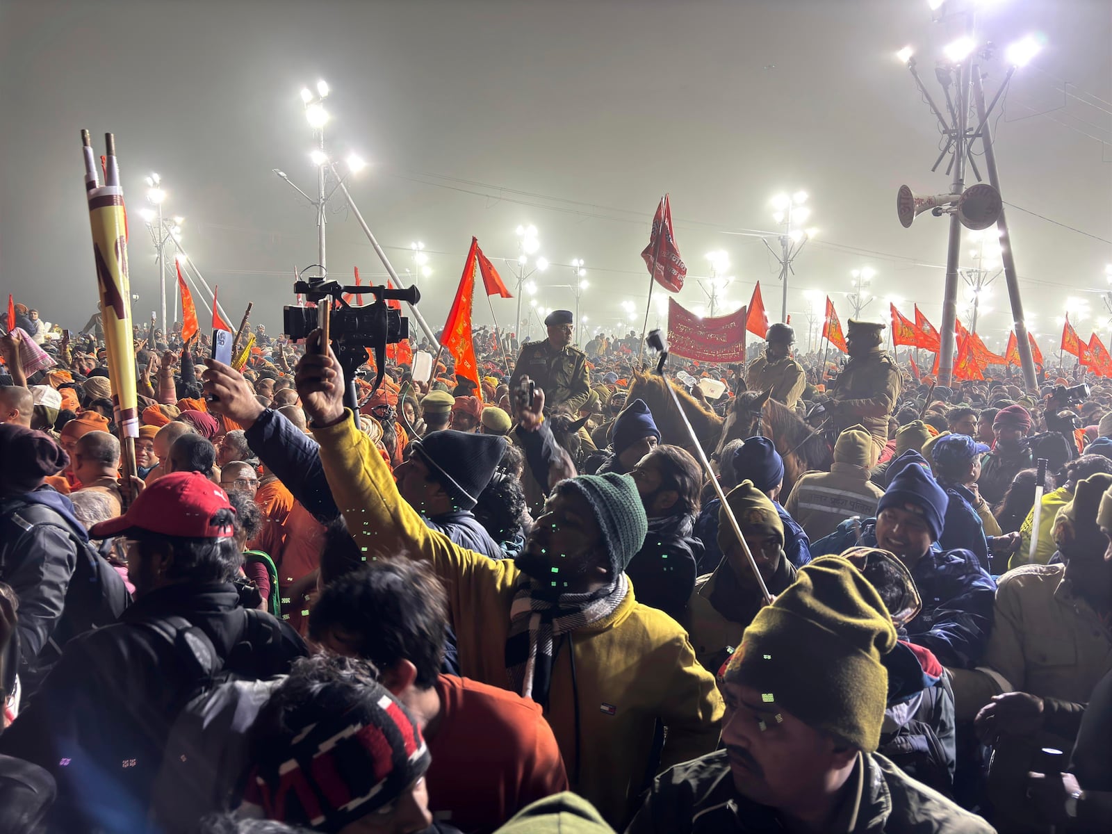 Policemen on horseback control the crowd at the confluence of the Ganges, the Yamuna and the mythical Saraswati rivers on Makar Sankranti, an auspicious bathing day of the 45-day-long Maha Kumbh festival in Prayagraj, India, Tuesday, Jan. 14, 2025. (AP Photo/Ashwini Bhatia)