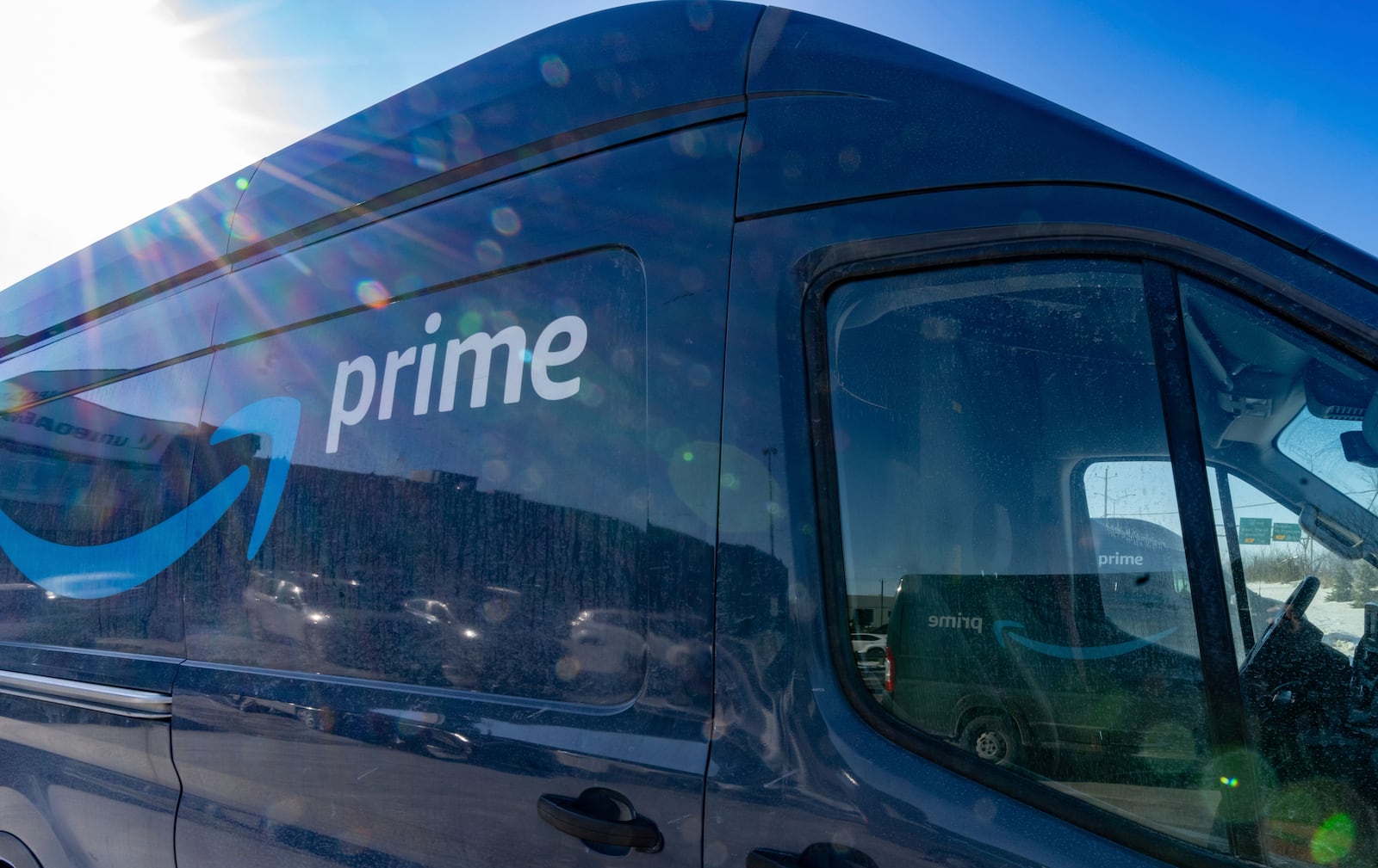 Delivery trucks are parked outside Amazon's DXT4 warehouse in Laval, Que., Wednesday, Jan. 22, 2025. Amazon Canada says it is closing all seven of its warehouses in Quebec. (Christinne Muschi /The Canadian Press via AP)