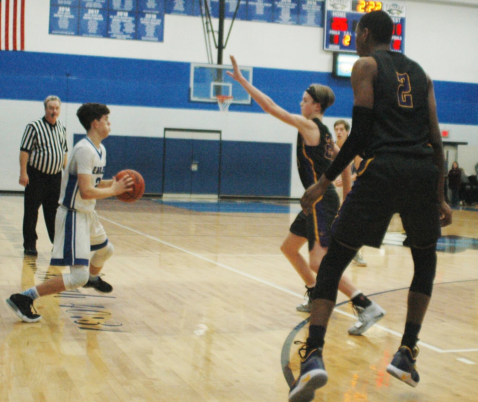 Dayton Christian’s Devin Dreier (23) and Anton Webb (2) come after Middletown Christian’s Camden Robertson during Friday night’s game at MCS. Dayton Christian won 53-41. RICK CASSANO/STAFF