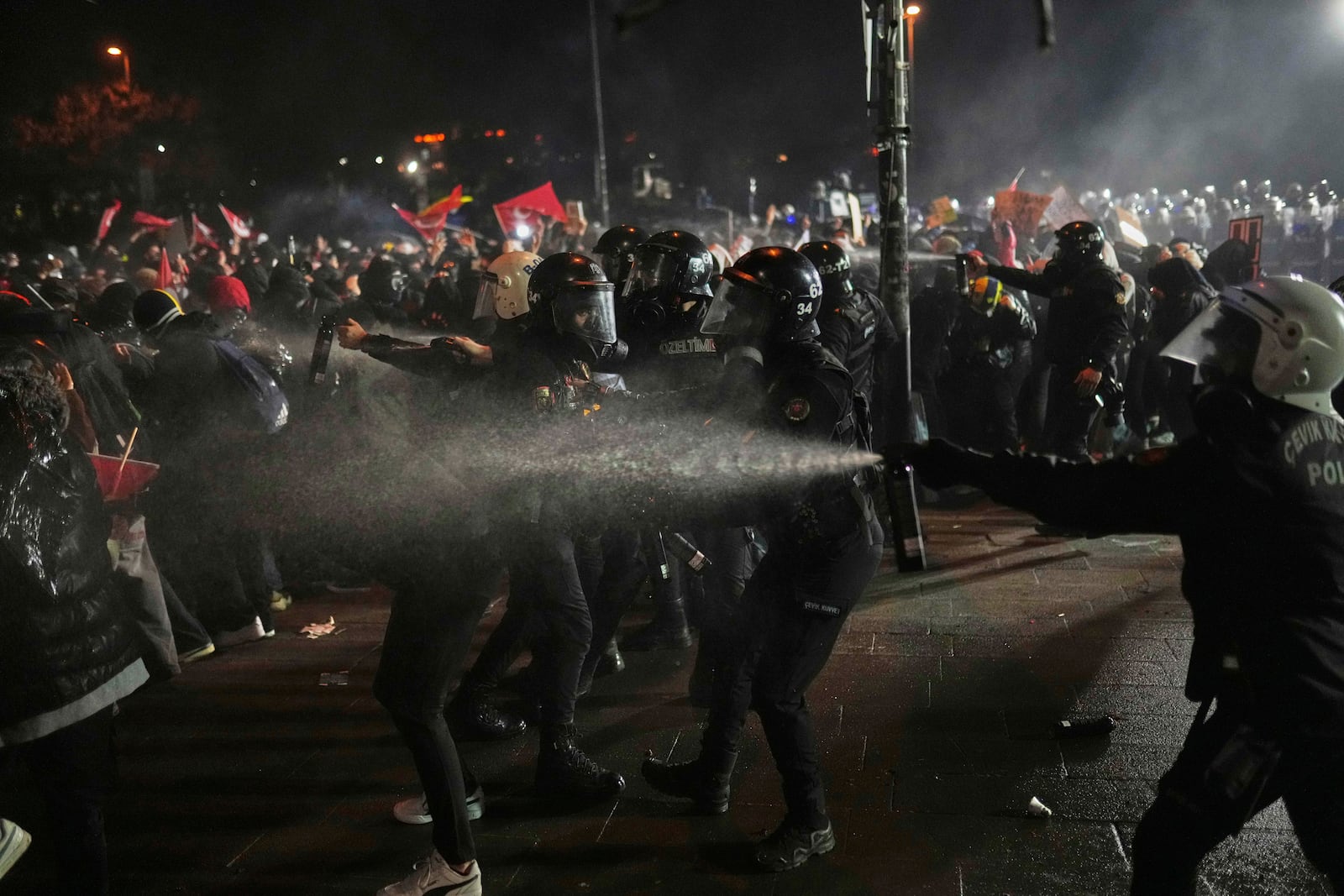 Riot police officers clash with protesters during a protest after Istanbul's Mayor Ekrem Imamoglu was arrested and sent to prison, in Istanbul, Turkey, Sunday, March 23, 2025. (AP Photo/Francisco Seco)