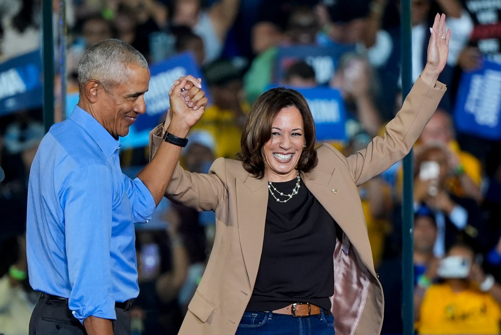 Former President Barack Obama holds hands with Democratic presidential nominee Vice President Kamala Harris after introducing her to speak during a campaign rally for Harris on Thursday, Oct. 24, 2024, in Clarkston, Ga. (AP Photo/Mike Stewart)