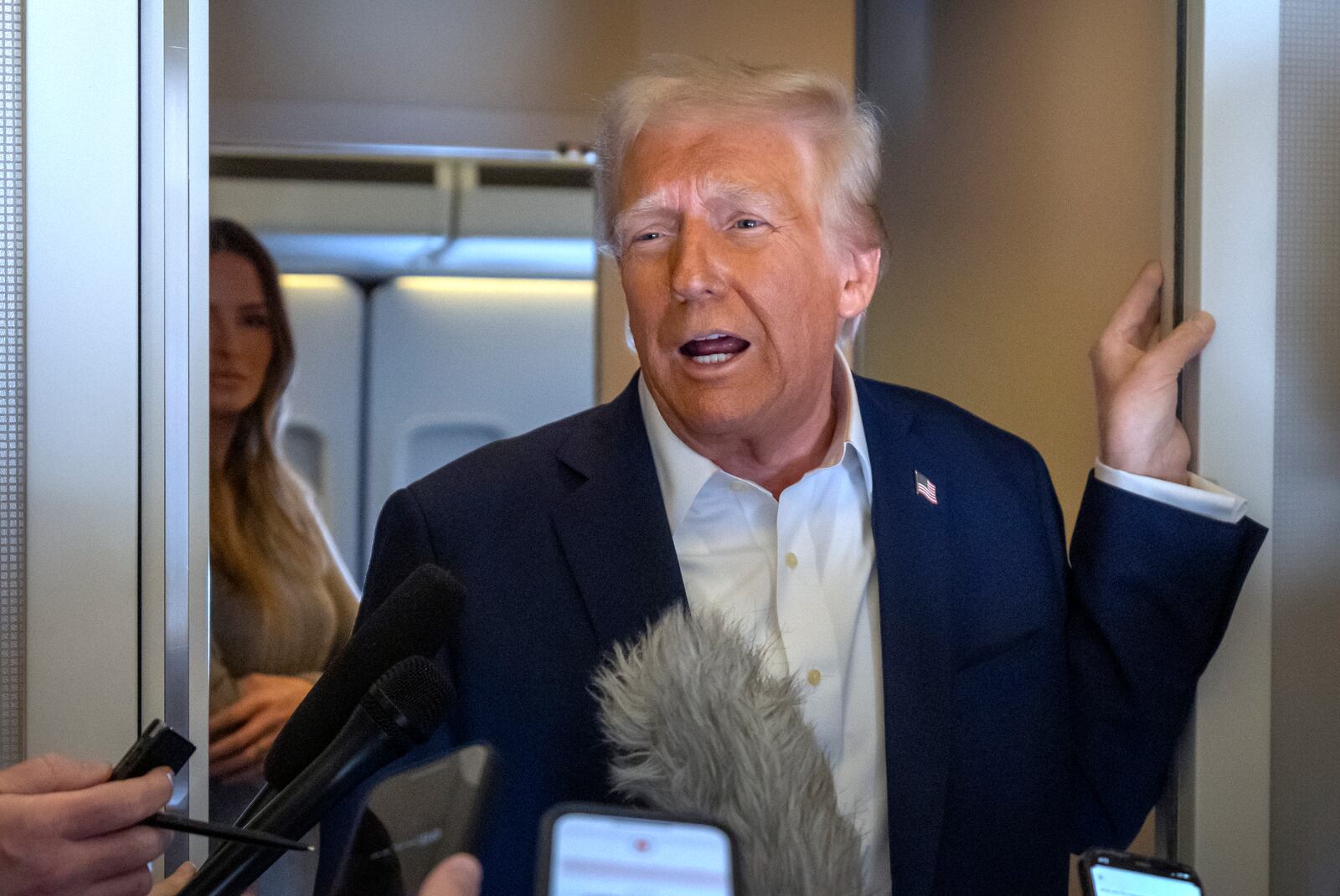 President Donald Trump speaks to reporters aboard Air Force One as he travels from Las Vegas to Miami on Saturday, Jan. 25, 2025. (AP Photo/Mark Schiefelbein)