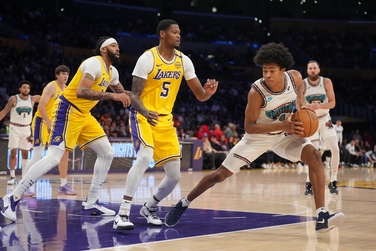 Memphis Grizzlies forward Jaylen Wells (0) dribbles next to Los Angeles Lakers forward Cam Reddish (5) during the first half of an NBA basketball game Wednesday, Nov. 13, 2024, in Los Angeles. (AP Photo/Marcio Jose Sanchez)