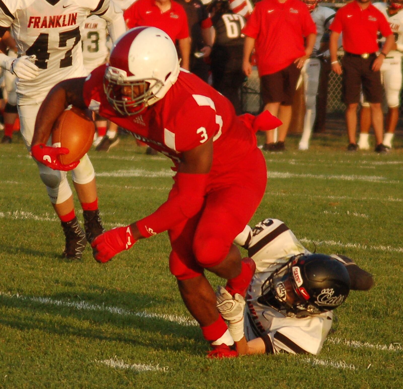 Carlisle running back D.J. Chambers tries to escape the tackle attempt by Franklin’s Zach Bowermaster on Friday night at Laughlin Field in Carlisle. The visiting Wildcats won 47-14. CONTRIBUTED PHOTO BY JOHN CUMMINGS