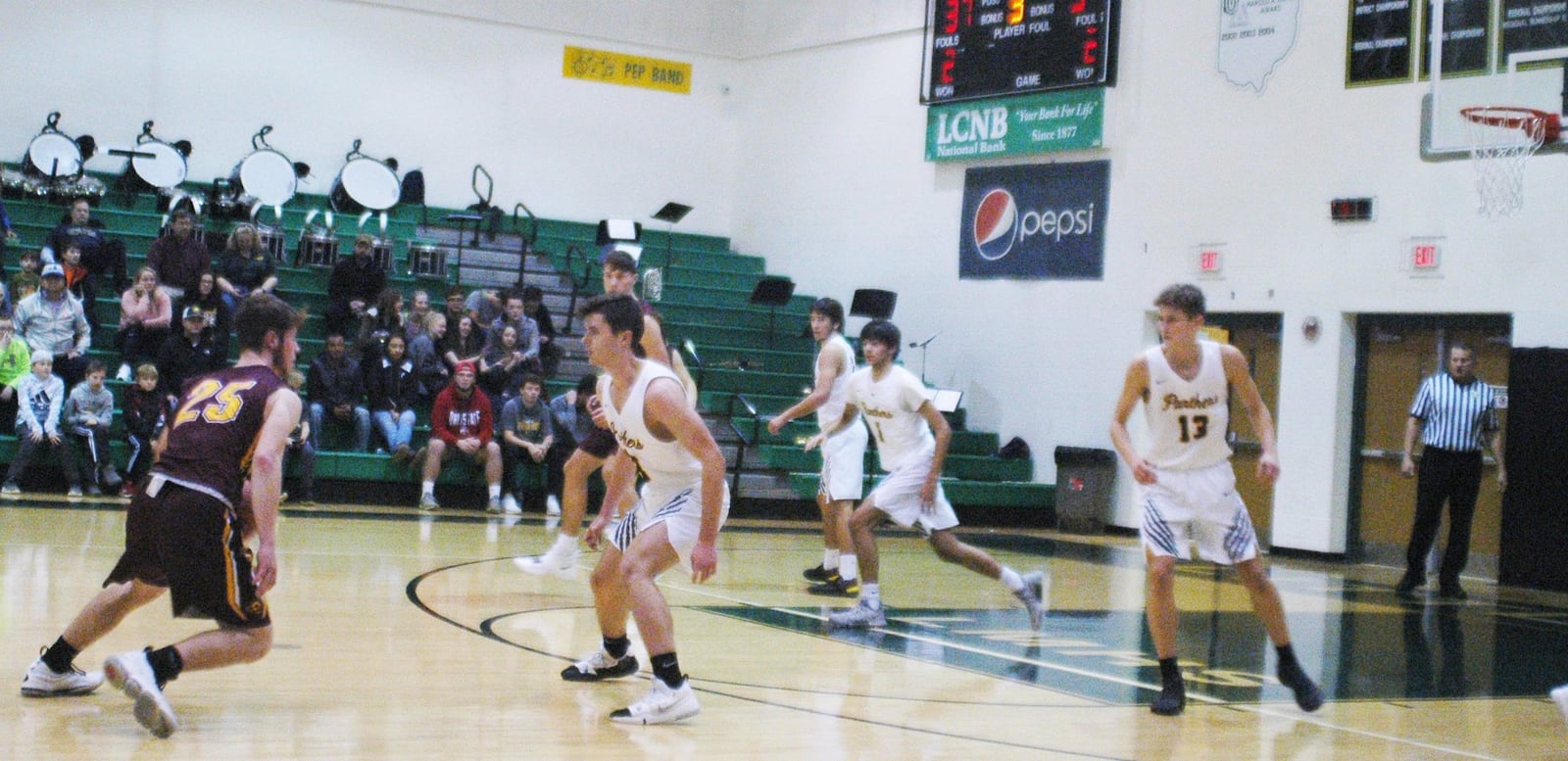 Cole Gronas (25) of Ross tries to make a move as he dribbles toward Little Miami’s Cole Spencer (23) during Friday night’s game at Little Miami. The host Panthers won 52-51. RICK CASSANO/STAFF