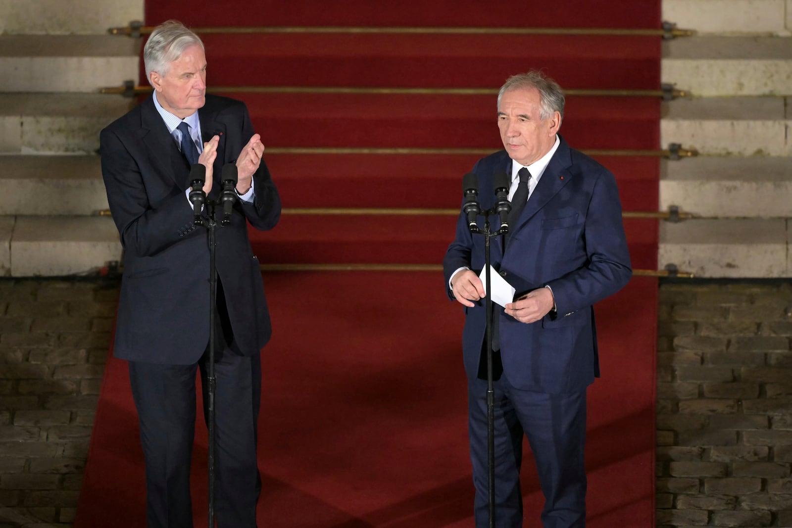 France's newly appointed Prime Minister Francois Bayrou, right, is applauded by outgoing Prime minister Michel Barnier after the handover ceremony at the Hotel Matignon, the Prime Minister residence, in Paris, Friday Dec. 13, 2024.( Bertrand Guay/ Pool via AP)