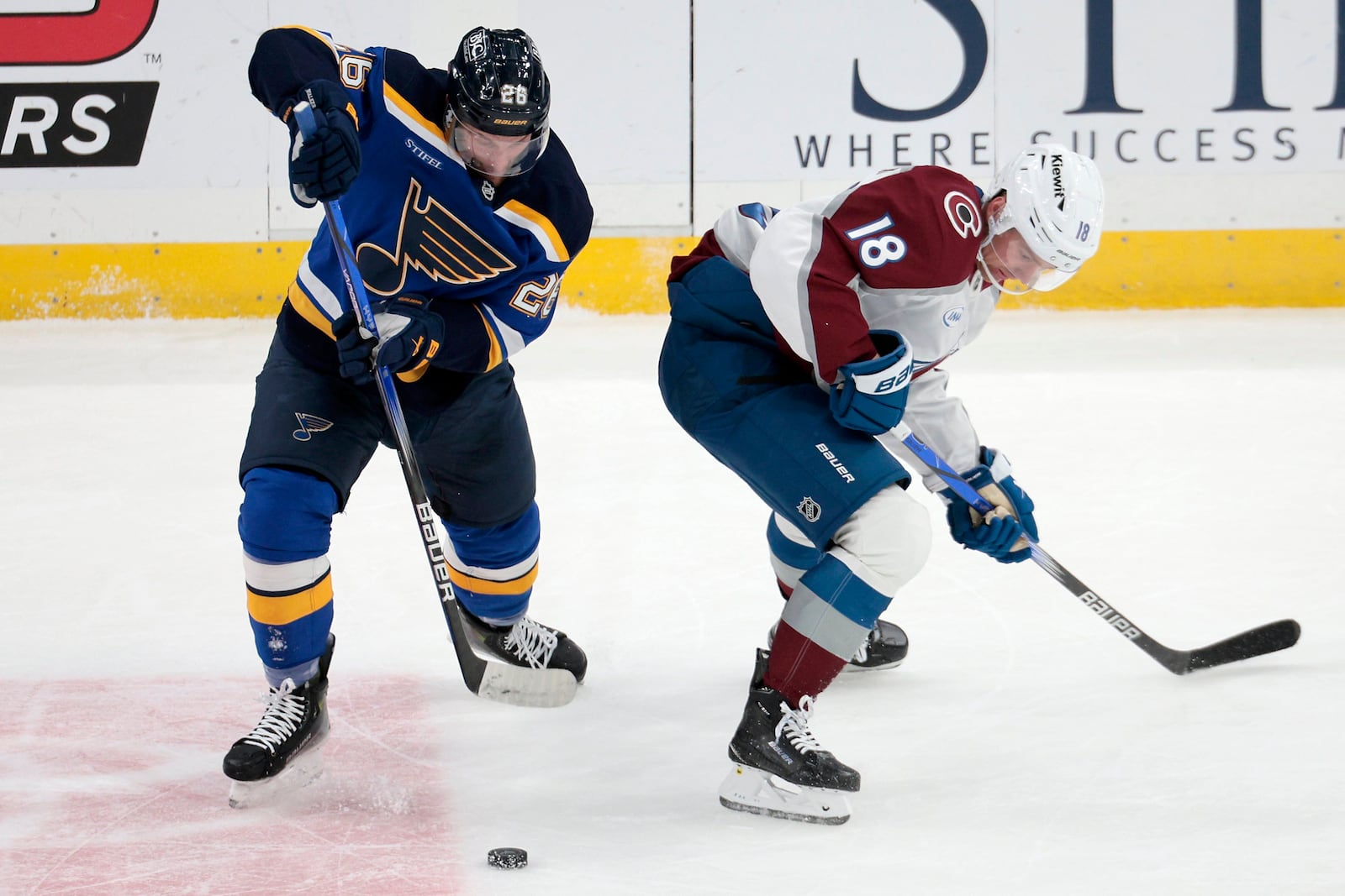 Colorado Avalanche center Juuso Parssinen and St. Louis Blues left wing Nathan Walker compete for the puck in the first period of an NHL hockey game in St. Louis on Sunday, Feb. 23, 2025. (Christian Gooden/St. Louis Post-Dispatch via AP)